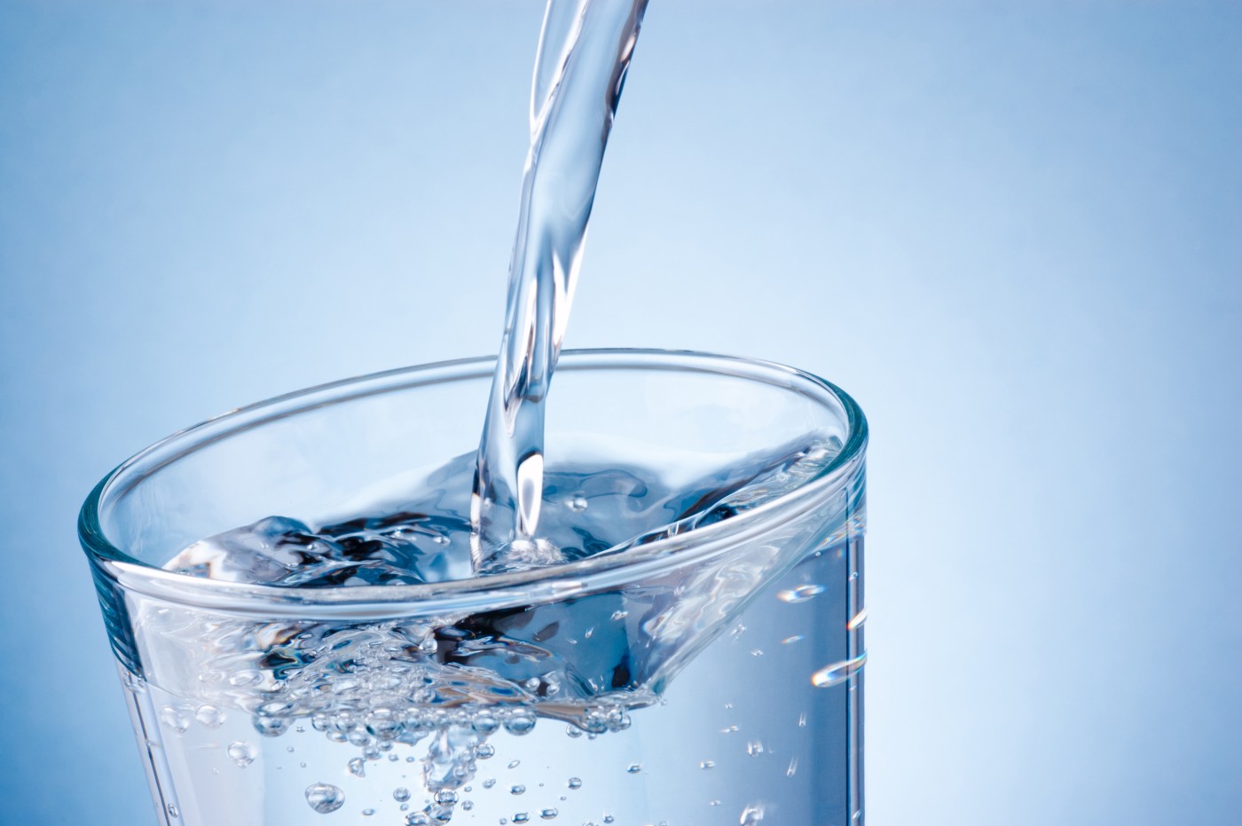 Pouring water in a cup. 