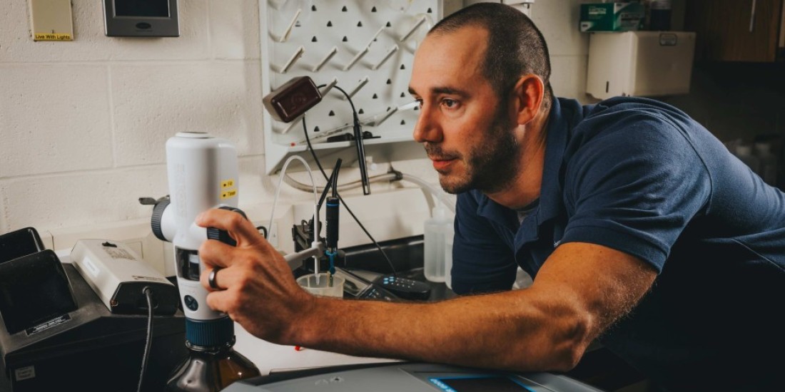 Guy focused on water tool 